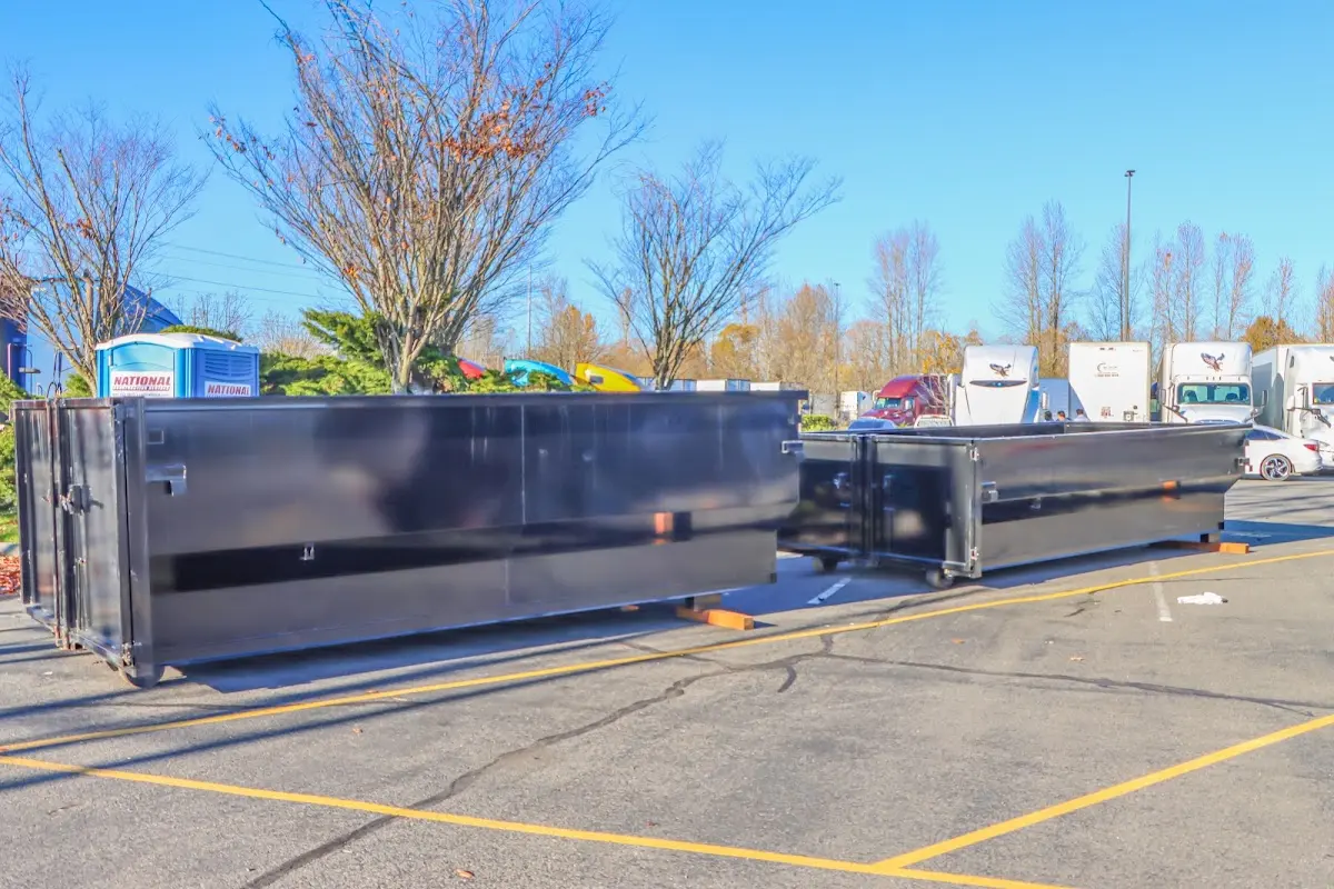 Professional dumpster rental service with roll-off container on residential driveway in Timnath